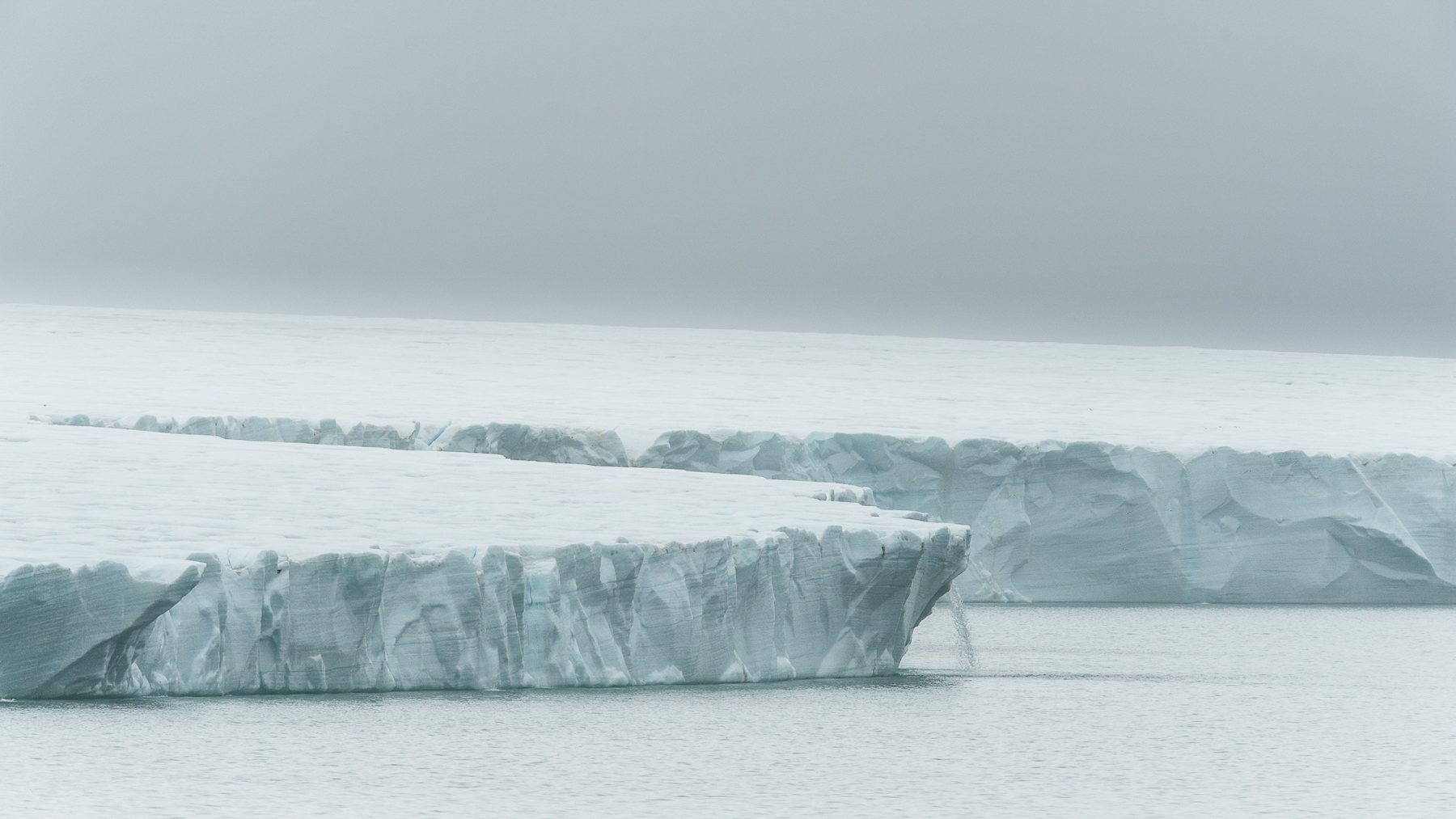 Ice caps cover parts of Svalbard and form low cliffs where they reach the sea