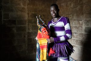 Behind the scenes with a Zaouli dancer on our photo tour of Ivory Coast