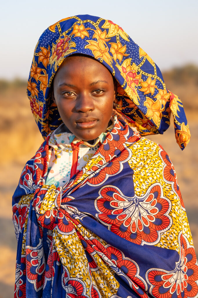 Early morning light casts a golden glow over an Ovakuvale woman in southern Angola (image by Ingrid Koedood)