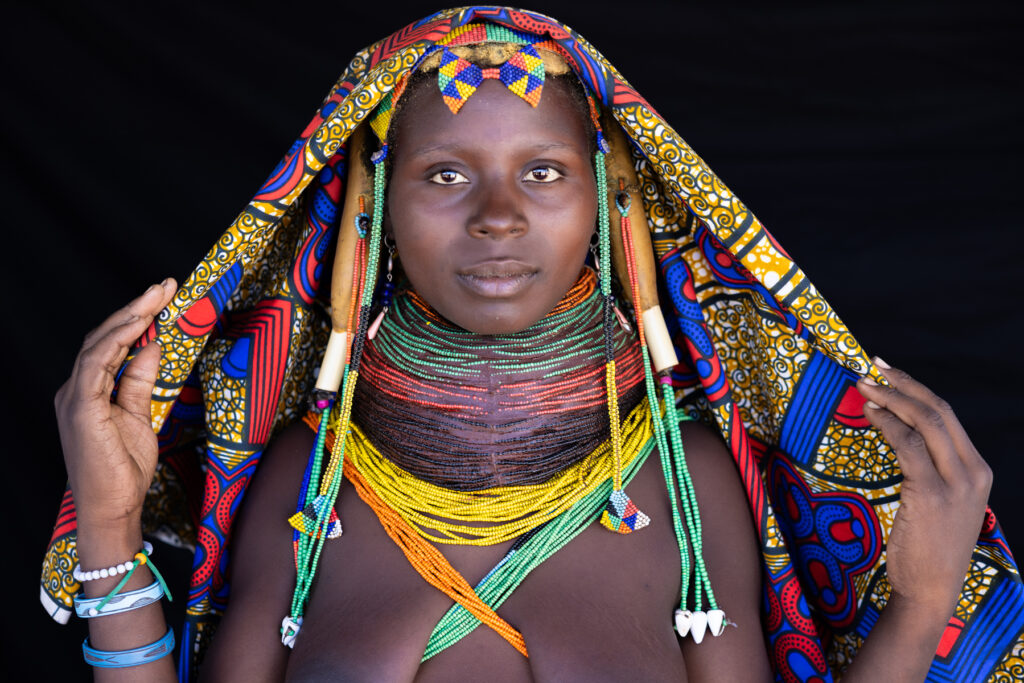 The natural beauty of Ovamwila women is distinguished by their elaborate Nontombe yellow hair braids and multi-coloured VIlanda necklaces that signify they are married. The fact that this woman was pregnant just added an extra layer to her beauty (image by Ingrid Koedood)