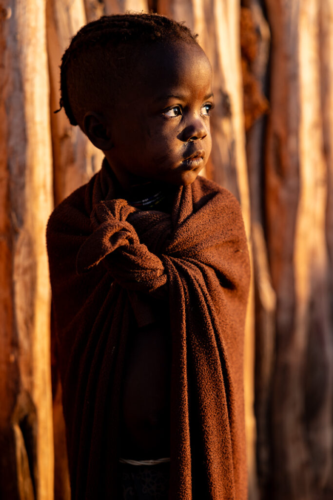 Portrait of a young child from the Ovatwa people, bathed in the soft glow of the morning light (image by Ingrid Koedood)