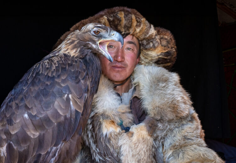 An eagle hunter with his bird. They have such intrinsic trust to never be hurt by any of the eagles they keep for a short time (image by Inger Vandyke)