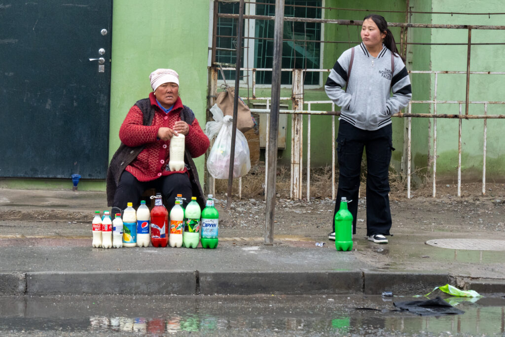 A local lady selling Airag (fermented mare's milk) on the cold, wintry streets of Khovd (image by Inger Vandyke)