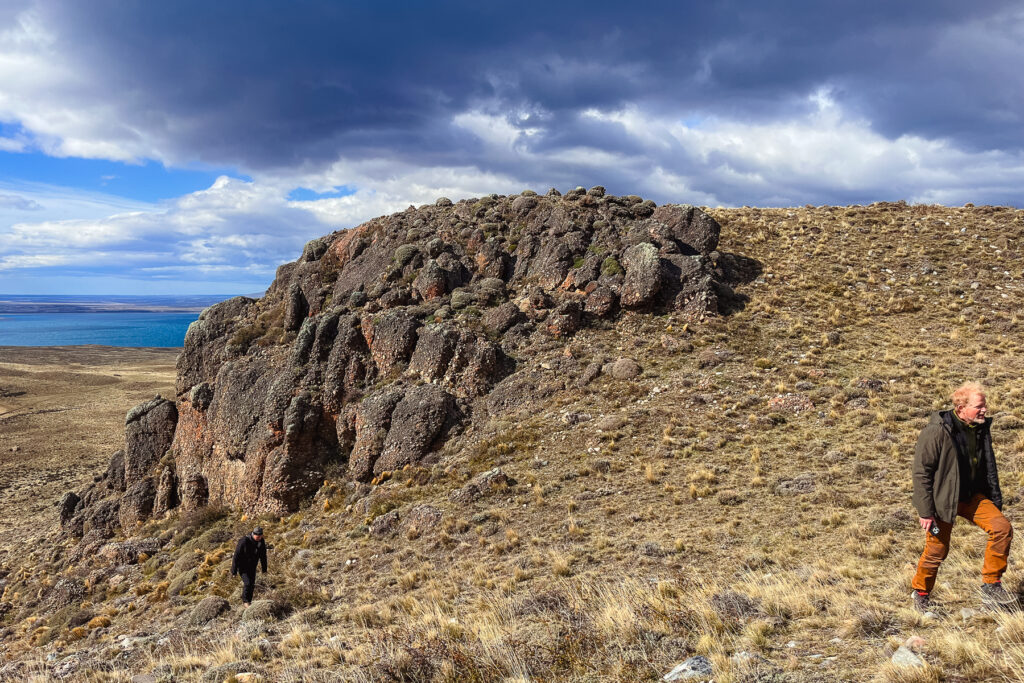 Clients Mark and Mario take a lunchtime stroll up one of the rock conglomerates in the Laguna Amarga reserve (image by Gin Wilde)